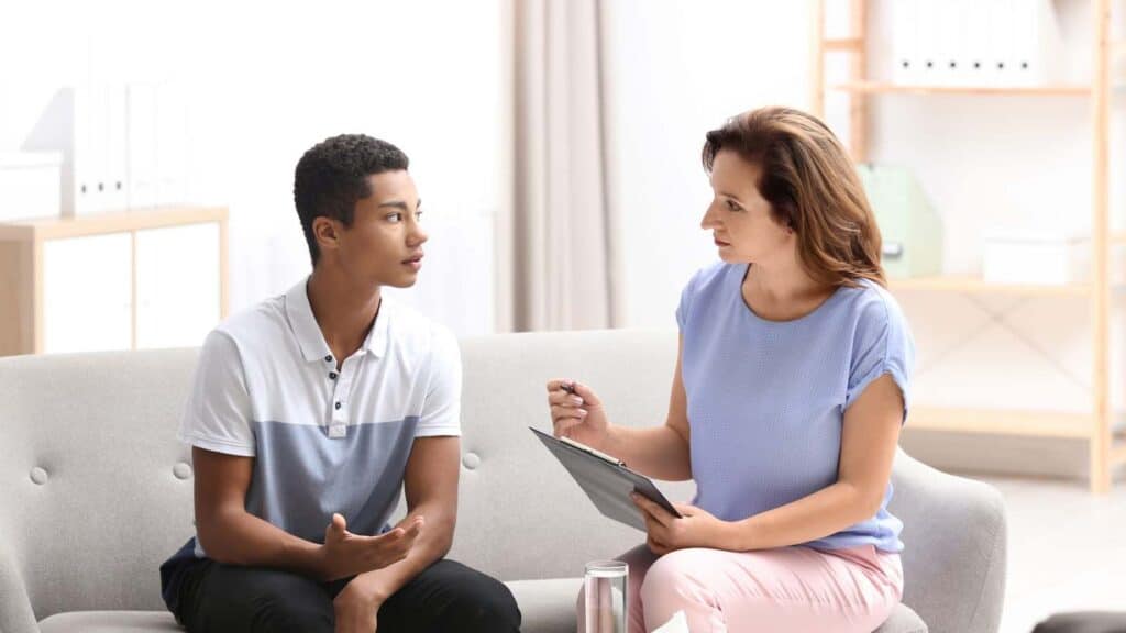 Therapist working with a young man