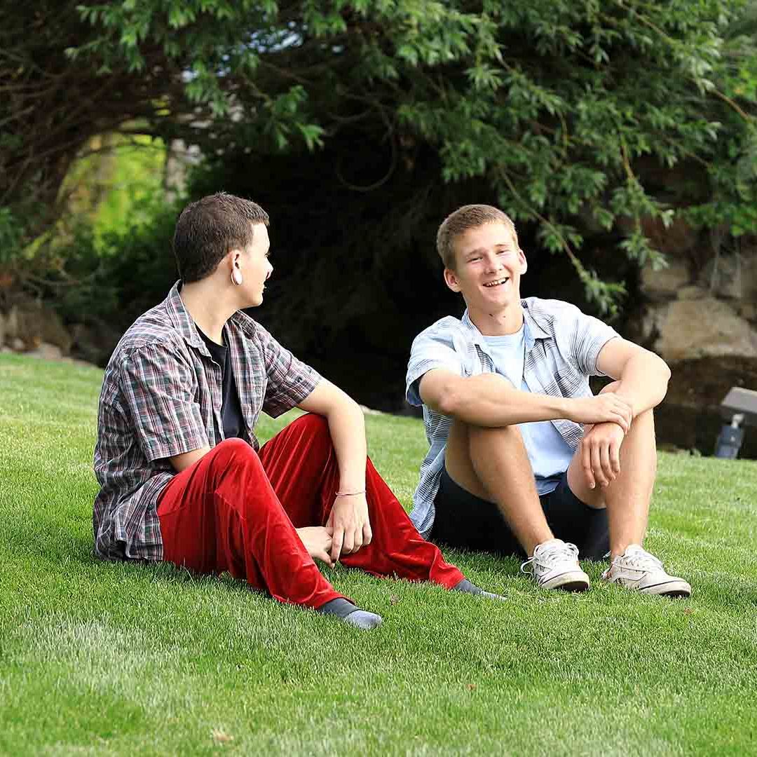 Boys Sitting on Grass talking